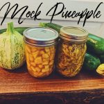 Zucchini in Pineapple juice in jars with zucchini on wooden board