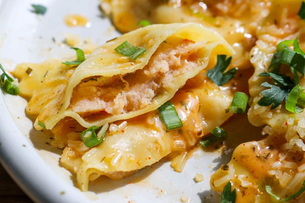 lobster ravioli cut in half with butter sauce