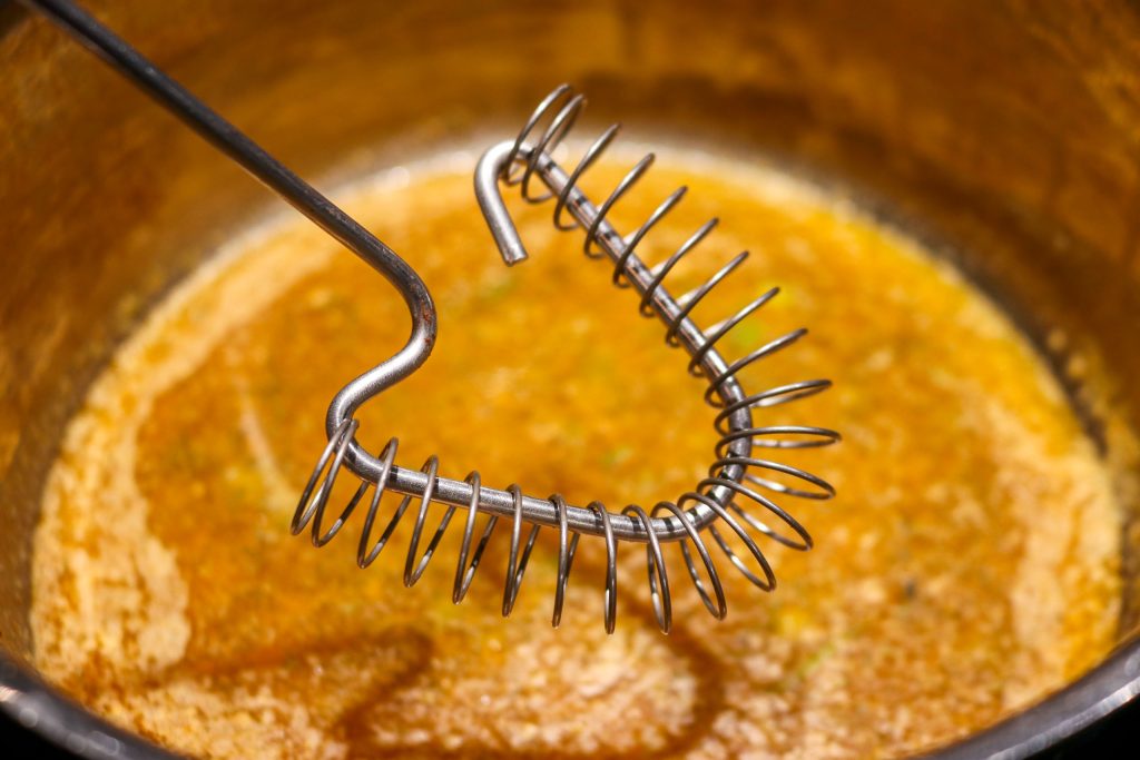 a flat whisk in a.saucepan of melted compound butter