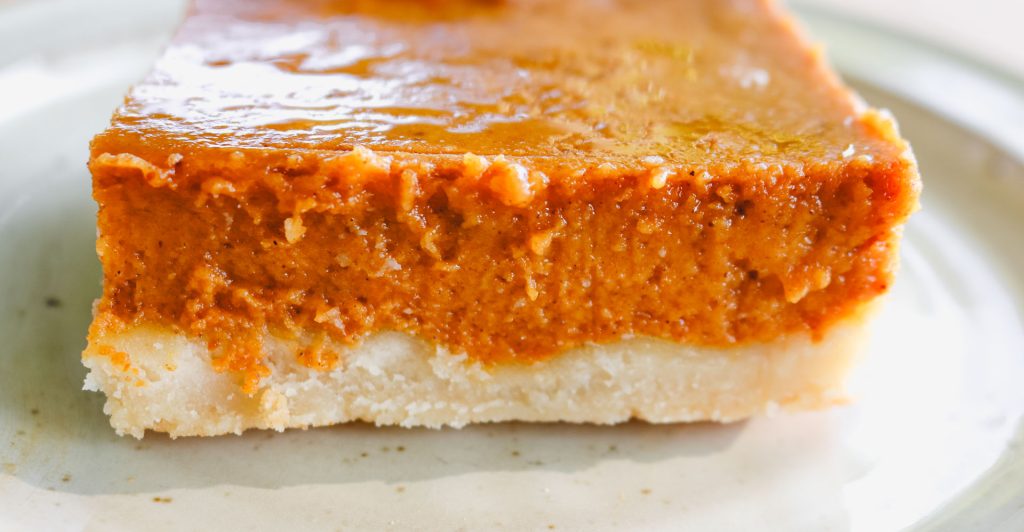 a pumpkin pie bar on a white plate