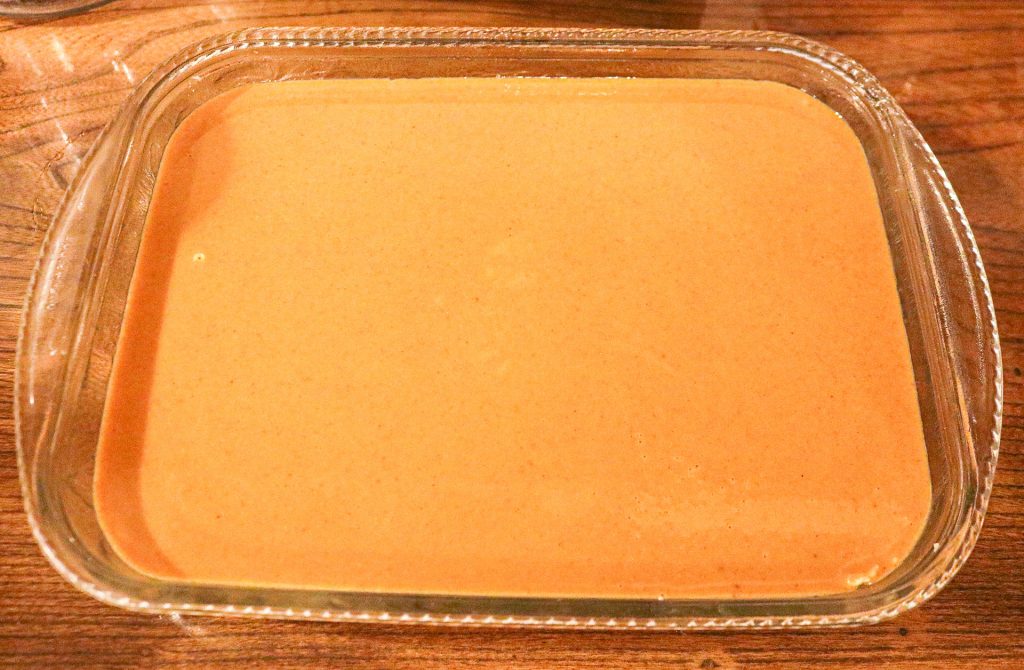Unbaked pumpkin pie filling in a 9x13