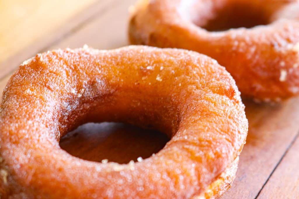 two pumpkins on a wooden counter