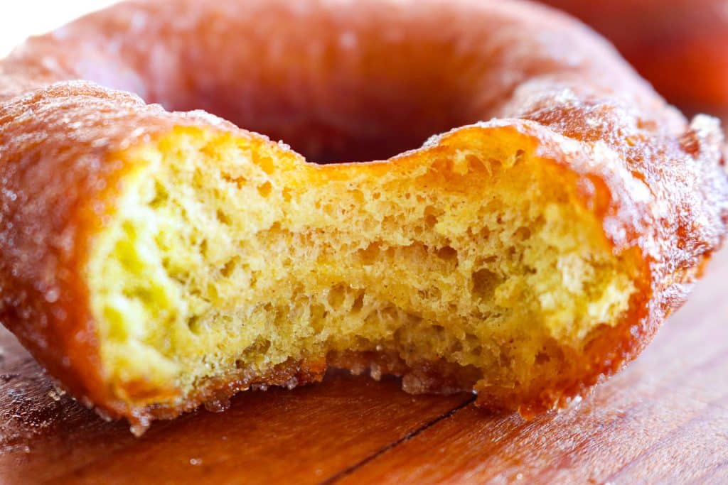 a pumpkin donut with a bite missing