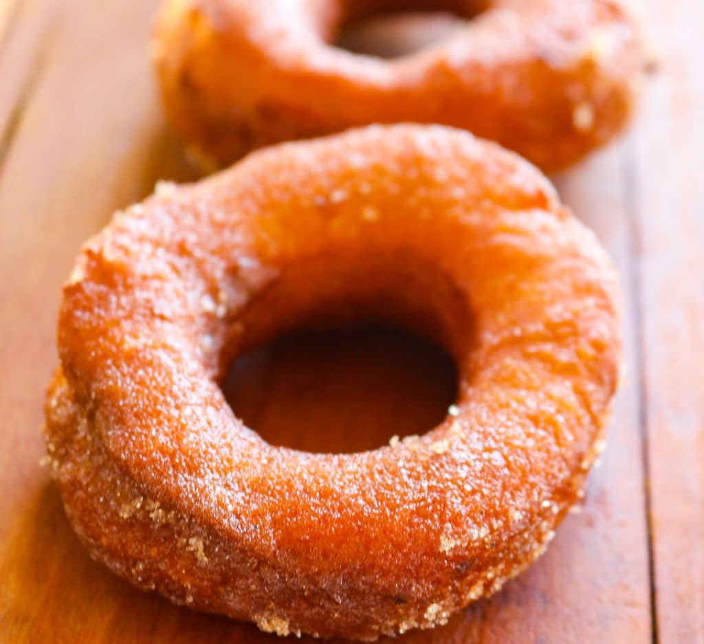donuts with sugar on a wooden counter