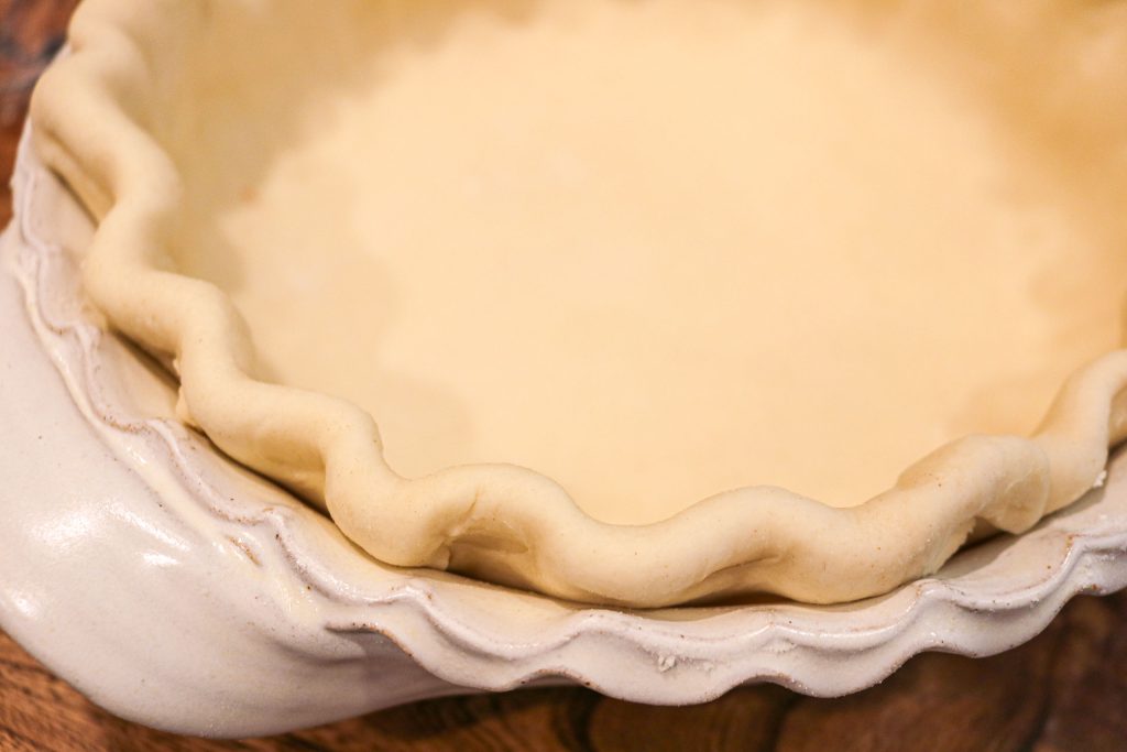 unbaked sourdough pie crust with a fluted edge