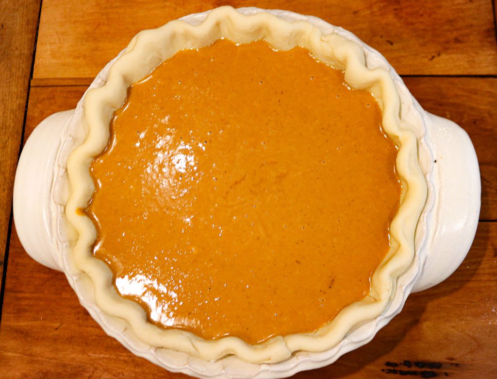 apple butter pumpkin pie filling in a sourdough pie crust unbaked