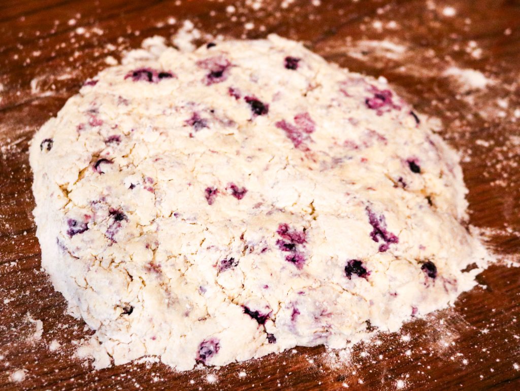 rolled out biscuit dough with blueberries